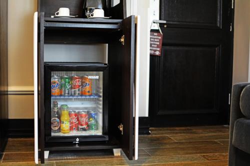 an open refrigerator with soda and drinks in it at Hotel Sommelier Boutique in Santiago