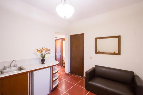 a kitchen with a sink and a chair in a room at Hotel Posada Loma in Fortín de las Flores