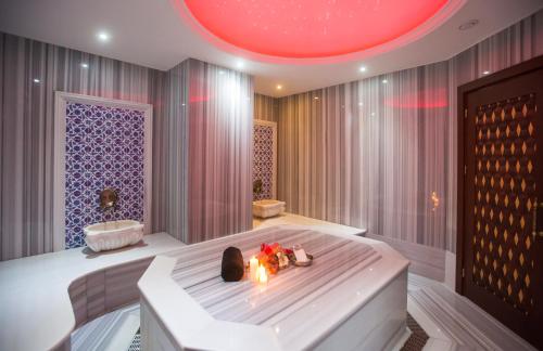 a bathroom with a bath tub with a red ceiling at Wyndham Batumi in Batumi