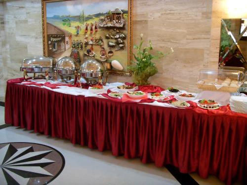 une table avec des assiettes de nourriture au-dessus dans l'établissement Hotel Arca lui Noe, à Sinaia