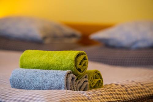 a pile of towels sitting on top of a bed at Penzion u lípy in Suchdol nad Lužnicí