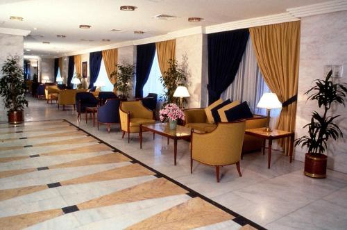 a lobby with chairs and tables in a hotel at Elaf Ajyad Hotel Makkah in Makkah