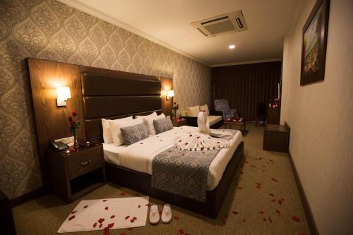 a hotel room with a bed with blood on the floor at Ankawa Royal Hotel & Spa in Erbil