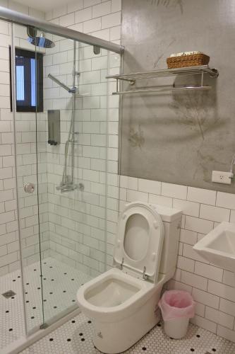 a bathroom with a toilet and a shower at 5963 Turn Right B&B in Jiaoxi