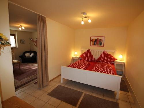 a bedroom with a bed with red pillows on it at Werner Ferienwohnung in Kappel-Grafenhausen