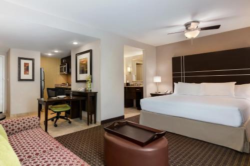 a hotel room with a bed and a desk at Homewood Suites by Hilton Joplin in Joplin
