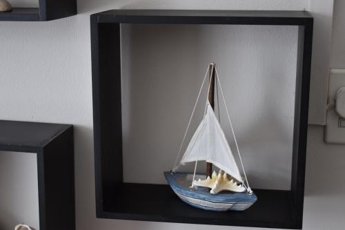 a toy boat with a starfish on a shelf at Goedgedacht Guestrooms in Potchefstroom