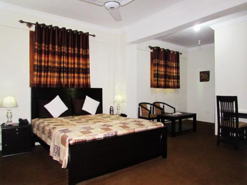 Postel nebo postele na pokoji v ubytování Stargaze Hotel & Apartment