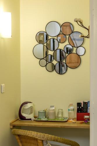 a bunch of glasses on a shelf on a wall at Les Chambres de Jeannette in Marseille