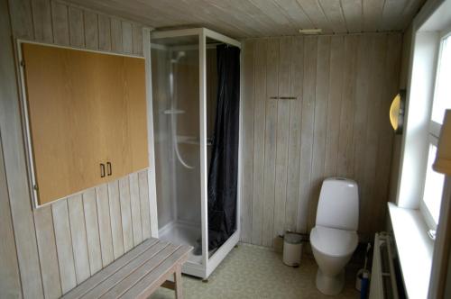 a bathroom with a toilet and a glass shower at Nr. Nebel Overnatning Hostel in Nørre Nebel