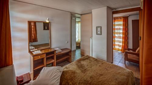 a bedroom with a large mirror and a bed at Zina Hotel Apartments in Athens