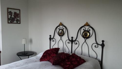 a bed with red pillows on it in a bedroom at La Casa di Bacco B&B in Lerma