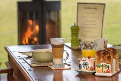 a table topped with two glasses of coffee and toast at Tarskavaig B&B in Radernie