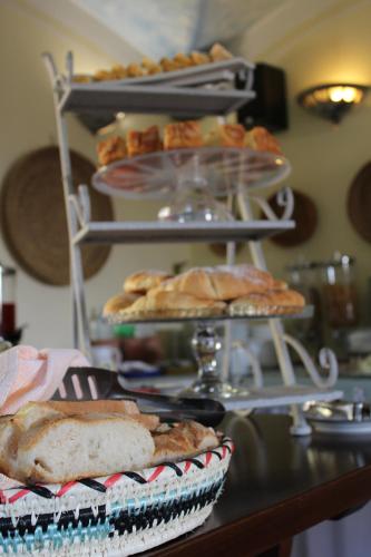 a table with a bunch of pastries and bread at Hotel Su Lithu in Bitti