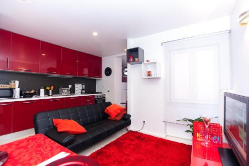 a living room with a couch and red cabinets at Ana's Design Apartments in Lisbon
