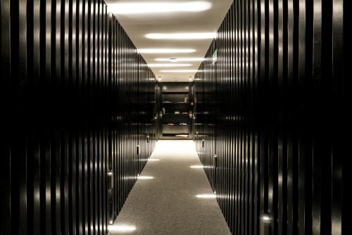 an empty hallway with black wooden walls and lights at Aire Hotel & Ancient Baths in Almería