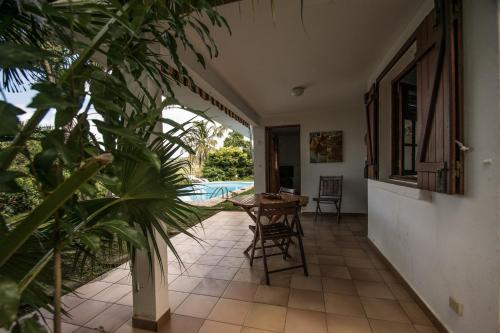 a corridor of a house with a table and some plants at La muscade in Ferry