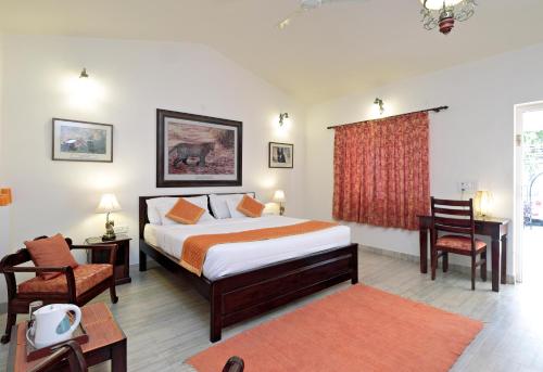 a bedroom with a bed and a desk and a chair at Pratap Bhawan Homestay in Jaipur