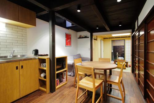 a kitchen and dining room with a table and chairs at Machiya Momiji in Kyoto