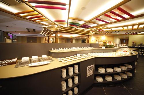 a store with a display of white bowls and plates at Taj Mahal Hotel in Hyderabad