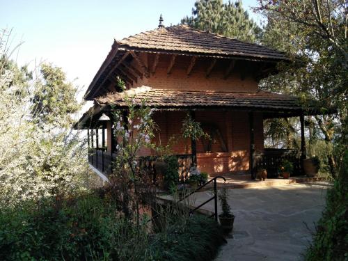 a small brick building with a staircase leading to it at The Fort Resort in Nagarkot