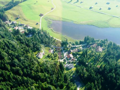 an aerial view of a village and a lake at Bäckeralm© - B&B 16 + in Mittenwald