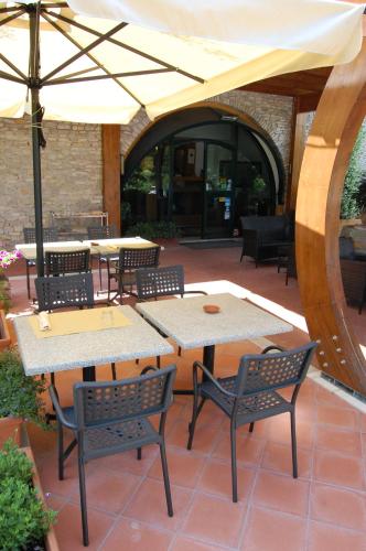 a patio with tables and chairs and an umbrella at Dal Patricano in Frosinone