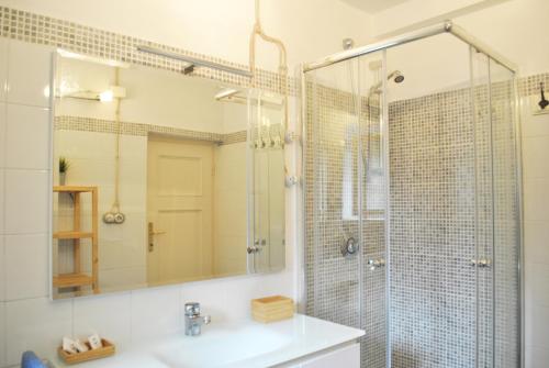 a bathroom with a sink and a shower with a mirror at Casetta in citta'- Seancity in Lucca