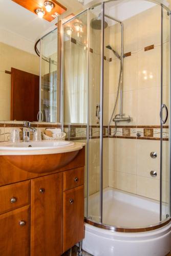 a bathroom with a shower and a sink at Heritage Hotel Vila Sikaa in Trogir