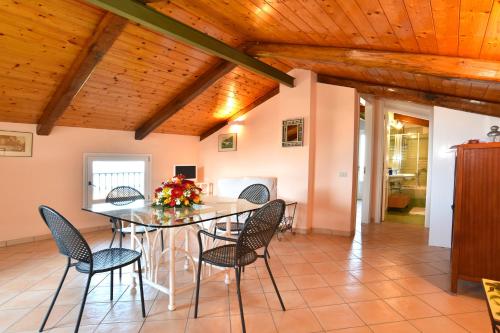a dining room with a table and chairs at La Ciucciara Holiday Homes in Massa Lubrense