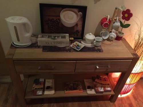 a wooden dresser with a table with various items on it at Hotel Penzion Trámky in Vikýřovice