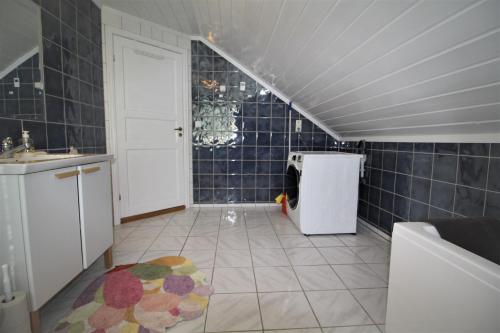 a small kitchen with a sink and a refrigerator at Stokke Apartment in Stokke