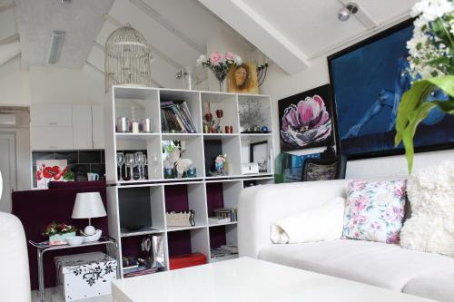a living room with a white book shelf at Art apartman in Kakanj