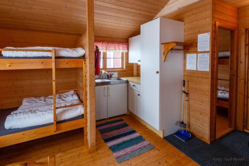 a bedroom with bunk beds in a cabin at BaseCamp NorthCape - by Hytte Camp in Skarsvåg