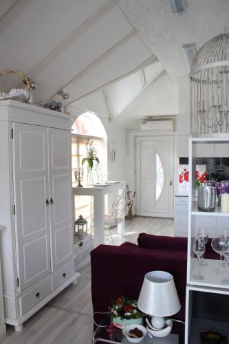a living room with a couch and a white cabinet at Art apartman in Kakanj