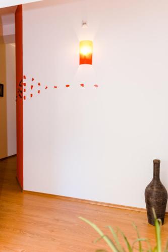 a room with a vase and a light on a wall at Frühstückspension Scharinger Hof in Gilgenberg am Weilhart