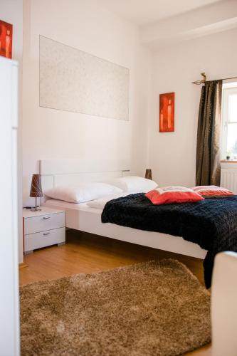 a bedroom with two beds and a rug at Frühstückspension Scharinger Hof in Gilgenberg am Weilhart