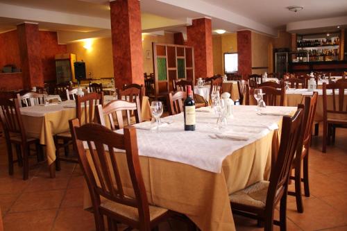 a dining room with a table with a bottle of wine at b&b Da Morena in Termoli