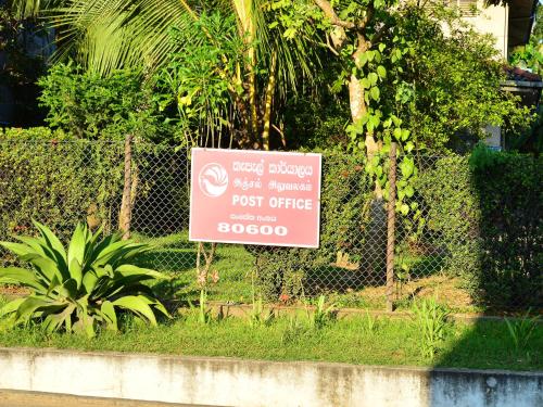 a sign on a fence that says expectinders just emergency post office at Villa Gaetano Unawatuna in Unawatuna