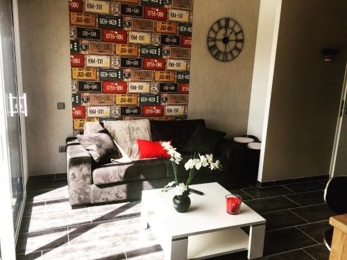 a living room with a couch and a table at Maison Landreau in Les Épesses