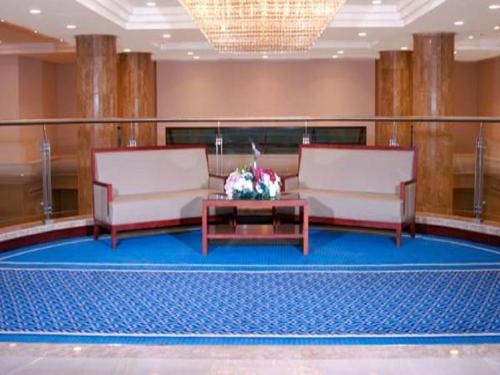 a living room with two chairs and a table at Makarem Mina Hotel in Makkah