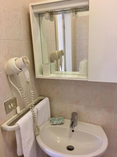 a bathroom with a sink and a mirror at La Lanterna in Garda