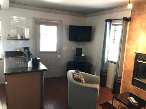 a living room with a couch and a kitchen with a fireplace at Oak Creek Terrace Resort in Sedona