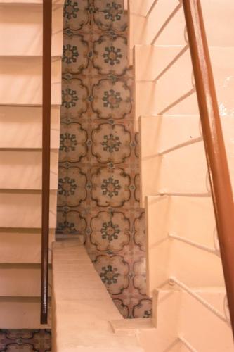 a stairway with a wall with a pattern on it at Casa Azzopardi Suites in Rabat