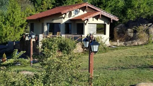 a house with a street light in front of it at Aires Serranos - Suites in La Cumbrecita