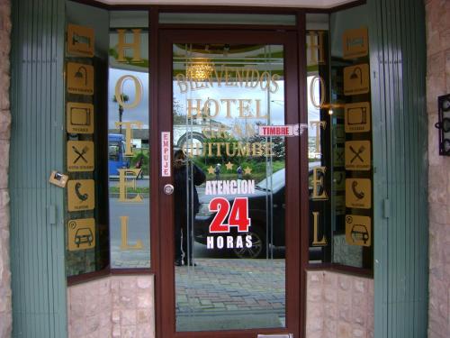 a store front door with a sign in the window at Hotel Gran Quitumbe in Quito