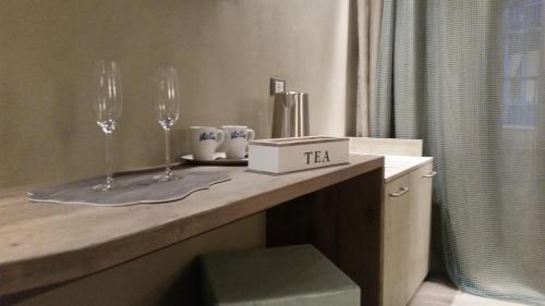 a counter with two wine glasses on top of it at Stellio Affittacamere - Guest House in Riomaggiore