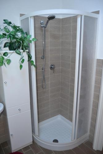 a shower with a glass door in a bathroom at Casa Tartaruga in SantʼAntìoco