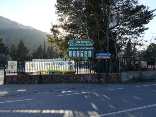 a gate with signs on the side of a road at Casa Fronte Gole Alcantara in Motta Camastra