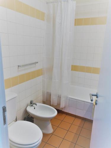 a bathroom with a toilet and a sink and a shower at Feel Funchal in Funchal
